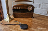 The Echo Input on a wooden desk with a speaker behind it.