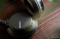 Sony WH-CH700N headphones on a cherry wood surface.