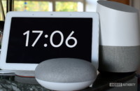 Photograph of Google Home Hub, Home Mini, and Home side by side