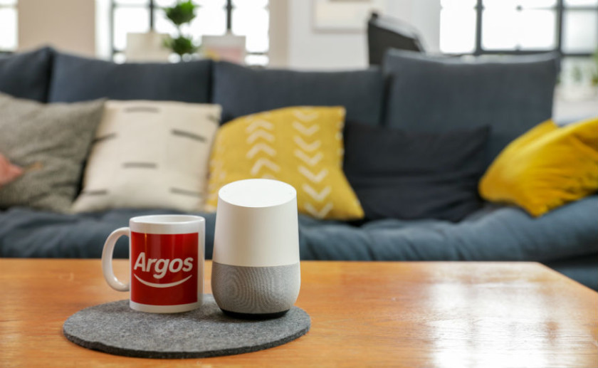 Argos logo on mug next to Google Home smart speaker - Black Friday