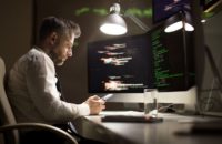 Coder Programmer Working Late on Computers