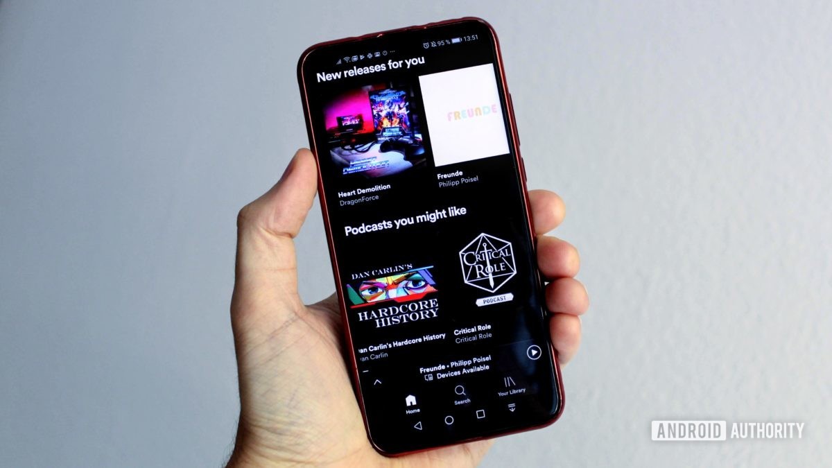 Spotify menu on a smartphone in a person's hand Spotify menu on a smartphone in a person's hand