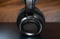 Philips Fidielio X27 open-back headphones on a black table.
