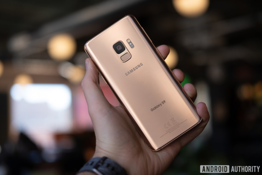 Samsung Galaxy S9 smartphone in sunrise gold in a person's hand.